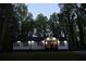 Charming home with black shutters, a red door, and surrounded by mature trees at 2798 Hutchins Rd, Lawrenceville, GA 30044