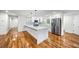 Modern kitchen with white cabinetry, stainless steel appliances, a large center island, and hardwood floors at 2798 Hutchins Rd, Lawrenceville, GA 30044