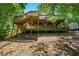 A view of the backyard with its multi-level decks and peaceful wooded setting at 4150 Kalb Sw Ct, Smyrna, GA 30082