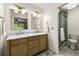 Bathroom with double sinks, vanity, modern fixtures, and glass shower at 4150 Kalb Sw Ct, Smyrna, GA 30082