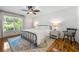 Cozy bedroom with hardwood floors, a large window, and modern furniture with a blue accent rug at 4150 Kalb Sw Ct, Smyrna, GA 30082