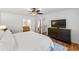 Bedroom with hardwood floors, ensuite bathroom, and dark wood dresser at 4150 Kalb Sw Ct, Smyrna, GA 30082