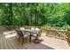 Outdoor deck with seating provides a serene space surrounded by lush greenery at 4150 Kalb Sw Ct, Smyrna, GA 30082