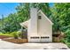 Rear home exterior with garage, deck access, and a lush, green backdrop at 4150 Kalb Sw Ct, Smyrna, GA 30082