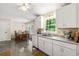Bright kitchen and dining area featuring white cabinets, modern appliances, and lots of natural light at 4150 Kalb Sw Ct, Smyrna, GA 30082