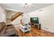Bright living room with hardwood floors, a staircase, and a comfortable sofa with plenty of seating at 4150 Kalb Sw Ct, Smyrna, GA 30082