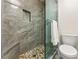 Walk-in shower features stone tile, a pebble floor, and a glass enclosure at 4150 Kalb Sw Ct, Smyrna, GA 30082