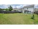 Expansive backyard with green grass, swing set, and a privacy fence, perfect for outdoor activities at 5322 Burrus Sw Ln, Mableton, GA 30126