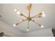 Close-up of modern gold sunburst chandelier in eat-in kitchen at 5322 Burrus Sw Ln, Mableton, GA 30126