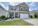 Charming two-story home with a brick and siding exterior, well-manicured lawn, and attached two-car garage at 5322 Burrus Sw Ln, Mableton, GA 30126