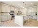 Bright kitchen features gray cabinets, stainless appliances, granite counters, and island with seating at 5322 Burrus Sw Ln, Mableton, GA 30126