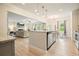 Open kitchen and living area features granite counters, stainless appliances, and island with breakfast bar at 5322 Burrus Sw Ln, Mableton, GA 30126