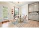 Eat-in kitchen with white cabinets, stylish round table, and chairs at 5322 Burrus Sw Ln, Mableton, GA 30126
