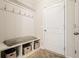 Well-organized mudroom with storage bench, hooks, and a patterned rug at 5322 Burrus Sw Ln, Mableton, GA 30126