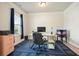 Well-lit home office setup with modern desk and comfortable rolling chair at 5322 Burrus Sw Ln, Mableton, GA 30126