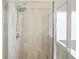 Close up of the tiled walk-in shower featuring a rainfall shower head at 5322 Burrus Sw Ln, Mableton, GA 30126