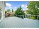 A spacious wooden deck offers an inviting outdoor living space with views of the lush backyard and mature trees at 2321 Norbury Se Cv, Smyrna, GA 30080