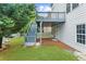 The backyard features a wooden deck with stairs to the manicured lawn, perfect for outdoor entertaining at 2321 Norbury Se Cv, Smyrna, GA 30080