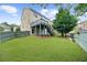 Landscaped backyard boasts a well-maintained lawn, mature trees, and a wooden deck, creating an ideal outdoor oasis at 2321 Norbury Se Cv, Smyrna, GA 30080
