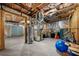 Unfinished basement with exposed ceiling, cement foundation, utility equipment, and storage at 2321 Norbury Se Cv, Smyrna, GA 30080