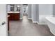 Bathroom with double vanity, soaking tub, and tiled floors for a spa-like experience at 2321 Norbury Se Cv, Smyrna, GA 30080