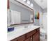 Bathroom featuring a large mirror, a white countertop, and a wooden vanity with ample storage at 2321 Norbury Se Cv, Smyrna, GA 30080