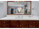 Bathroom vanity featuring wooden cabinets, white countertops, and a large mirror reflecting the spacious room at 2321 Norbury Se Cv, Smyrna, GA 30080
