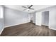 Bedroom featuring a ceiling fan, light gray walls, hardwood floors, closet and access to other rooms at 2321 Norbury Se Cv, Smyrna, GA 30080