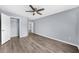 Bedroom featuring a ceiling fan, light gray walls, hardwood floors, and a closet at 2321 Norbury Se Cv, Smyrna, GA 30080