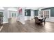 Elegant dining room featuring modern lighting, a dark accent wall and hardwood floors at 2321 Norbury Se Cv, Smyrna, GA 30080