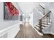 Entryway with hardwood floors, staircase, and decorative accents at 2321 Norbury Se Cv, Smyrna, GA 30080