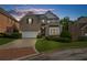Charming two-story brick home with well-manicured lawn and a brick-lined driveway at 2321 Norbury Se Cv, Smyrna, GA 30080