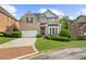 Charming two-story brick home with well-manicured lawn and a brick-lined driveway at 2321 Norbury Se Cv, Smyrna, GA 30080