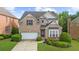 Two-story brick home with well-maintained landscaping at 2321 Norbury Se Cv, Smyrna, GA 30080