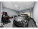 Garage featuring a gray car, epoxy floors, overhead lights, and mechanics tools at 2321 Norbury Se Cv, Smyrna, GA 30080