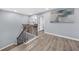 Upstairs hallway showcasing a staircase with metal spindles, light hardwood floors, and art on the walls at 2321 Norbury Se Cv, Smyrna, GA 30080