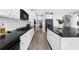 Open-concept kitchen features a large center island, black countertops and stainless steel appliances at 2321 Norbury Se Cv, Smyrna, GA 30080
