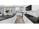 Bright kitchen features white cabinets, granite countertops, stainless appliances, and hardwood floors at 2321 Norbury Se Cv, Smyrna, GA 30080