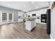 Spacious kitchen with a center island, white cabinetry, stainless steel appliances, and hardwood floors at 2321 Norbury Se Cv, Smyrna, GA 30080