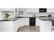 Modern kitchen with white cabinets, black countertops, and stainless steel appliances at 2321 Norbury Se Cv, Smyrna, GA 30080
