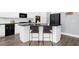 Kitchen island with seating and dark granite countertops with white cabinets at 2321 Norbury Se Cv, Smyrna, GA 30080