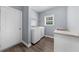 Laundry room featuring hardwood floors, gray walls, sink, and modern washer and dryer at 2321 Norbury Se Cv, Smyrna, GA 30080