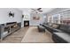 This living room has hardwood floors, a cozy fireplace, lots of windows, and neutral colors at 2321 Norbury Se Cv, Smyrna, GA 30080