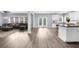 Open floor plan with bright living room and a kitchen with an island and white cabinets at 2321 Norbury Se Cv, Smyrna, GA 30080