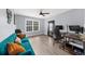 Bright home office space with a blue velvet couch, large window, and neutral colors, offering a comfortable workspace at 2321 Norbury Se Cv, Smyrna, GA 30080