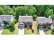 An aerial view shows a home with a well-manicured lawn and mature trees at 475 Bayswater Way, Suwanee, GA 30024