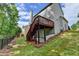 An attractive backyard features a two-story deck and lush landscaping at 475 Bayswater Way, Suwanee, GA 30024