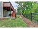 Backyard featuring a wooden staircase and metal fence on a grassy lawn at 475 Bayswater Way, Suwanee, GA 30024