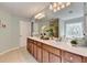 Elegant bathroom features a double vanity, large mirror, and decorative window providing natural light at 475 Bayswater Way, Suwanee, GA 30024