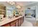Bright bathroom features a double vanity, soaking tub, step-in shower, and an open doorway to the bedroom at 475 Bayswater Way, Suwanee, GA 30024